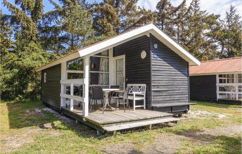 a small cabin with a table and chairs on a porch at Stunning Home In Nexø With Wifi in Neksø