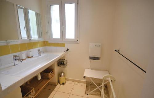 a white bathroom with a sink and a window at Le Clos De Rosa in Crillon-le-Brave