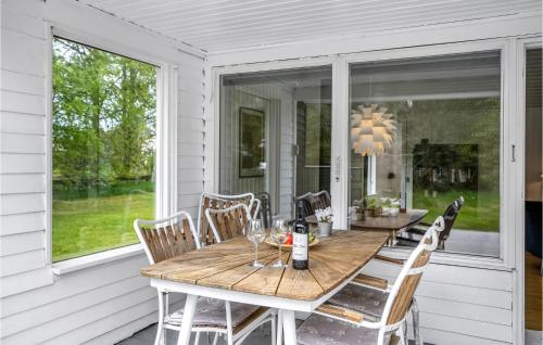 a wooden table on the front porch of a house at 3 Bedroom Pet Friendly Home In Ålbæk in Ålbæk