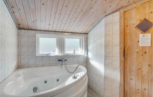 a bathroom with a tub and a window at Beautiful Home In Thisted With Kitchen in Thisted