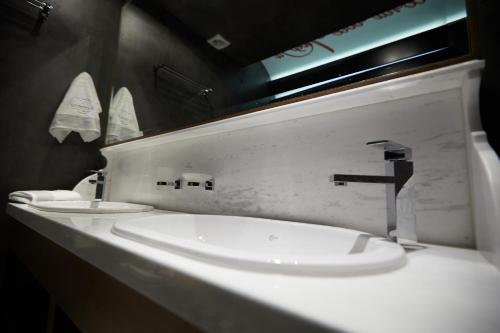 a bathroom with two sinks and a mirror at Veritas Boutique Art Hotel in Veria