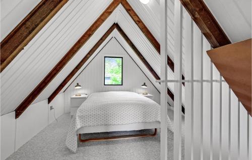 a bedroom with a white bed in a attic at Beautiful Home In Løgstrup With Wifi in Løgstrup