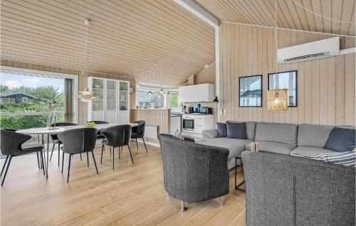 a living room with a couch and a table and chairs at Cozy Home In Løgstrup With Kitchen in Løgstrup