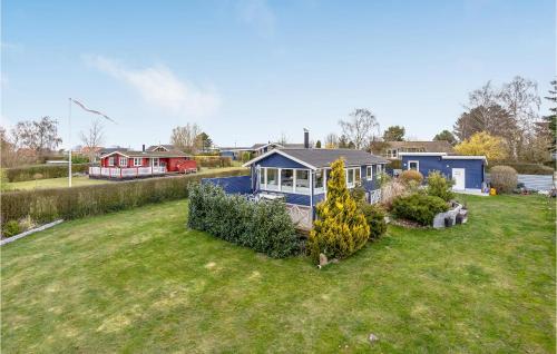 a house in a yard with a yard sidx sidx at Gorgeous Home In Bogø By With Wifi in Bogø By