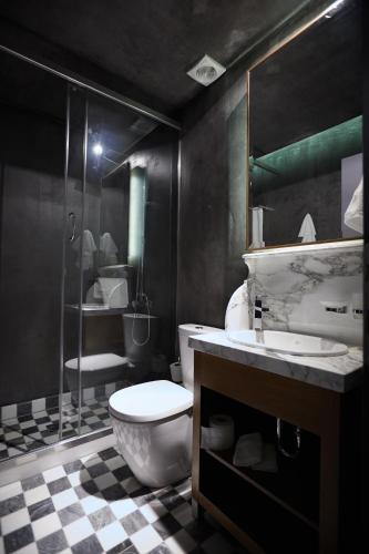 a bathroom with a toilet and a sink and a shower at Veritas Boutique Art Hotel in Veria