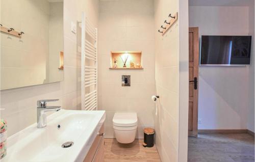 a white bathroom with a toilet and a sink at Beautiful Home In Angerville-lorcher With Wifi in Angerville-lʼOrcher