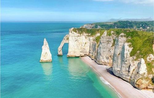 a beach with two large rocks in the water at Cozy Home In Angerville-L'orcher in Angerville-lʼOrcher
