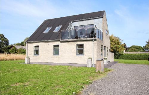 a house with a large window on the side of it at Beautiful Home In Sams With Wifi in Nordby
