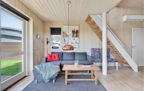 a living room with a couch and a table at Stunning Home In Faaborg With Wifi in Åstrup