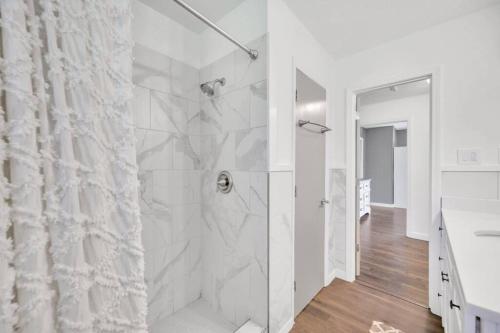 baño blanco con ducha y lavamanos en Cozy 4bedroom Bungalow in Davidson Sleeps 10, en Davidson