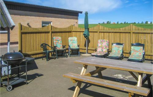 a patio with chairs and a table and a grill at 5 Bedroom Cozy Home In Hasle in Hasle