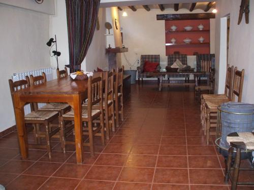 a dining room with a wooden table and chairs at Casa Rural en el campo - Mas de Tenesa in Benasal