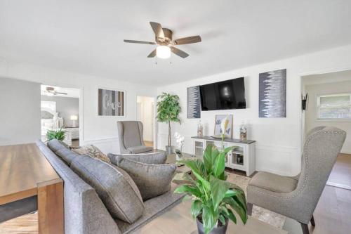 a living room with a couch and chairs and a ceiling fan at Cozy 4bedroom Bungalow in Davidson Sleeps 10 in Davidson
