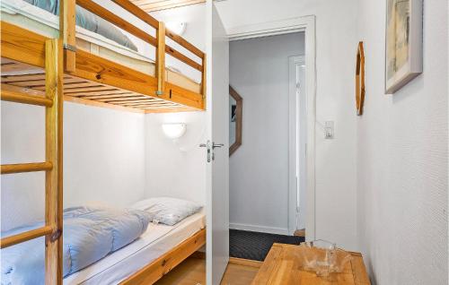 two bunk beds in a small room with a table at Lovely Home In Fredericia With Wifi in Fredericia