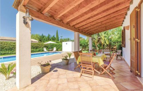 a patio with a table and chairs next to a pool at Villa Gina in Menfi