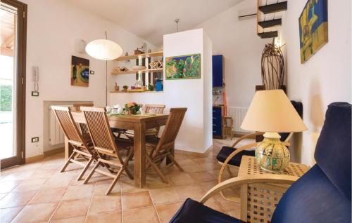a dining room and living room with a table and chairs at Villa Gina in Menfi