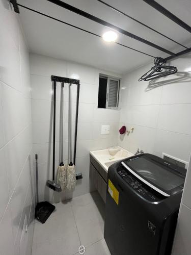 a bathroom with a sink and a washing machine at Apartamento privado con vista en el centro de B/ga in Bucaramanga