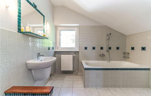 a bathroom with a sink and a bath tub at Awesome Apartment In Szklarska Poreba With Kitchen in Szklarska Poręba