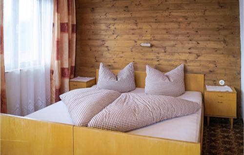 a bed with two pillows on it in a room at Stunning Home In Hippach-schwendberg With Wifi And 5 Bedrooms in Grün