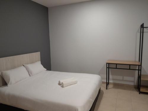 a bed with a roll of paper on top of it at The Great Hotel in Ipoh