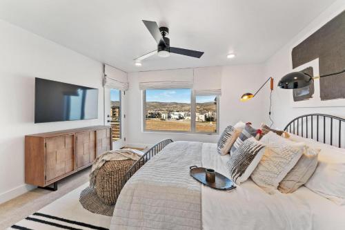 a bedroom with a bed and a flat screen tv at Modern Upscale Townhouse in Park City in Park City