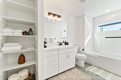 a white bathroom with a sink and a toilet at Modern Upscale Townhouse in Park City in Park City