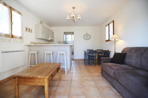 a living room with a couch and a table at Domaine de Suzel in Vignieu