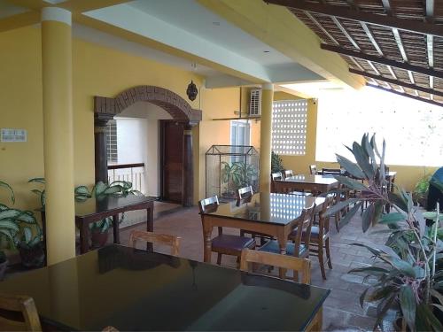 a restaurant with tables and chairs in a room at Ram Guest House in Puducherry