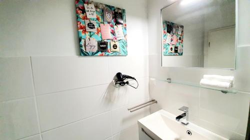 a white bathroom with a sink and a mirror at ☆WOW! Stylish Studio in Centre Near University☆ in Mannheim