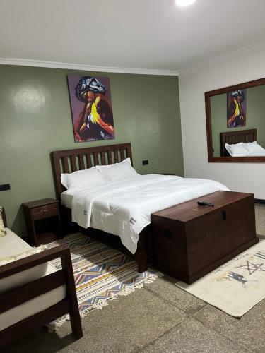 a bedroom with a bed and a table in it at Koselig Homes in Nanyuki
