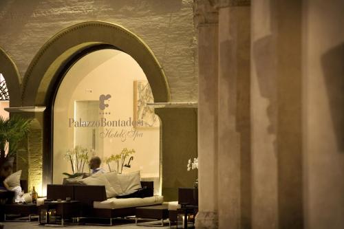 a person sitting on a couch in a store window at Palazzo Bontadosi Hotel & Spa in Montefalco