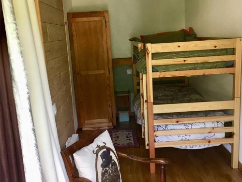 a room with two bunk beds and a door at Appartement Les Angles, 2 pièces, 4 personnes - FR-1-295-149 in Les Angles