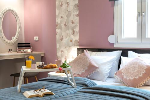 a bedroom with a bed and a table with a tray on it at Chania Design Suites in Chania Town
