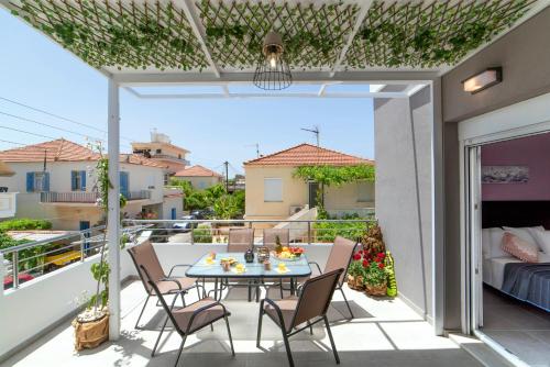 a patio with a table and chairs on a balcony at Chania Design Suites in Chania Town