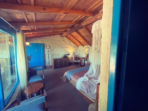 a bedroom with a large bed in a room at SHIVAYA since 1953 in Mukteswar