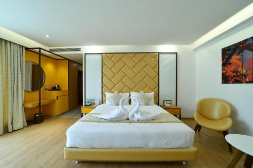 Tempat tidur dalam kamar di The President Hotel, kumarapark
