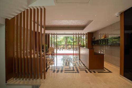 a hallway of a house with wooden walls and a staircase at The President Hotel, kumarapark in Bengaluru