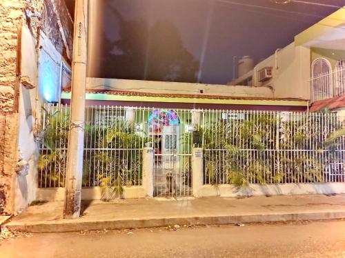 a fence in front of a building with plants at Casa Lool Beh in Mérida