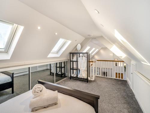 a attic bedroom with a bed and skylights at Ferndale Bungalow in Hambleton