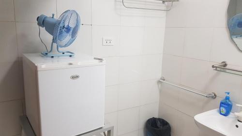 a bathroom with a blue fan on top of a counter at Paraiso Cave & Restaurant & Resort in San Francisco