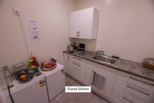 a kitchen with a sink and a counter top at The Amberley Hotel in Amberley
