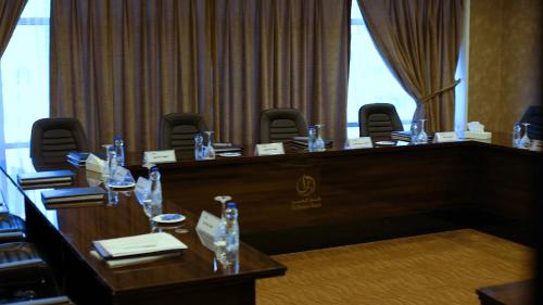a meeting room with a long table and chairs at AlHamra Hotel Kuwait in Kuwait