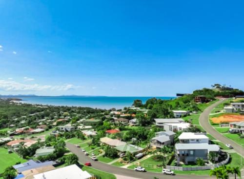 an aerial view of a town with the ocean in the background at Lammermoor Lodge Holiday Home Yeppoon in Yeppoon