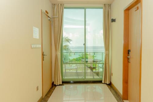a room with a large window with a view of the ocean at Season Holidays at Hulhumale with Transfer in Hulhumale
