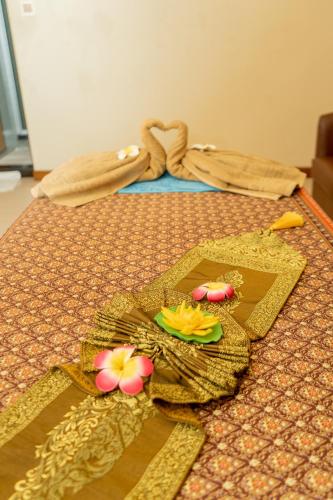 a table with a plate with flowers on it at Season Holidays at Hulhumale with Transfer in Hulhumale