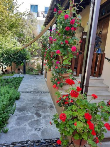 a bunch of red flowers on the side of a building at Vasilion Agrotourism in Polis Chrysochous