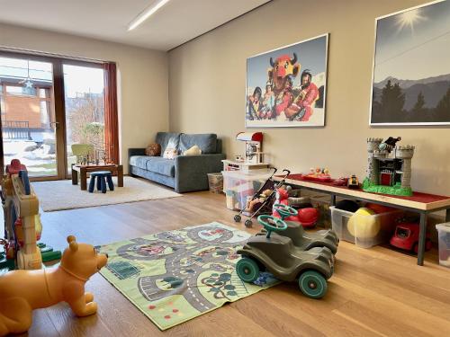 a living room filled with toys on a wooden floor at Apartment Pale in Fiss
