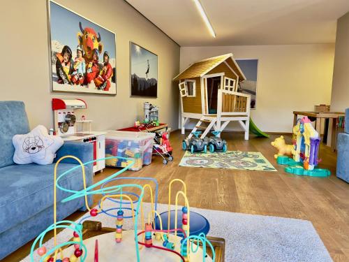 a living room filled with toys and a blue couch at Apartment Pale in Fiss