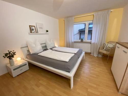 a bedroom with a bed and a large window at Ferienwohnung Vater Rhein Mittelrheintal in Sankt Goar