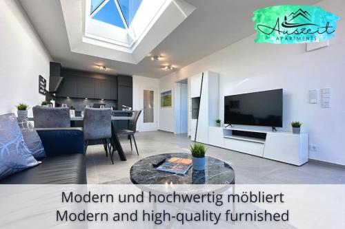 una sala de estar con un moderno e ineficiente mobiliario moderno y de alta calidad en Auszeit Apartment SUNSHINE am Uferpark - nur 100 m bis zum Bodensee, direkt am Bodenseeradweg, 2 Schlafzimmer, 2 sonnige Dachterrassen, schnelles WLAN, kostenloser Tiefgaragenstellplatz, für bis zu 4 Personen, en Friedrichshafen